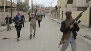 Gunmen fighters walk in streets of the city of Ramadi