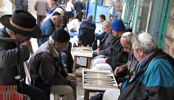 TO GO WITH AFP STORY BY RON BOUSSO Israeli Jews of Iraqi origin play backgammon at the Iraqi area of Jerusalem's landmark Mahne Yehuda market on November 26, 2009. Signs of the changing times can be seen throughout the maze of narrow streets that make up Mahne Yehuda, which is known to locals simply as the "Shuk" -- Hebrew for market. AFP PHOTO/MARINA PASSOS (Photo credit should read MARINA PASSOS/AFP/Getty Images)